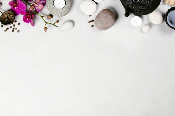 istock Asian tea set and spa stones on concrete background 928562866