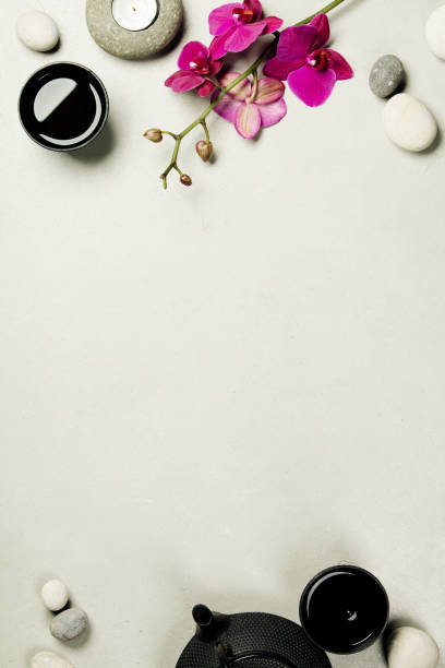 istock Asian tea set and spa stones on concrete background 928562882