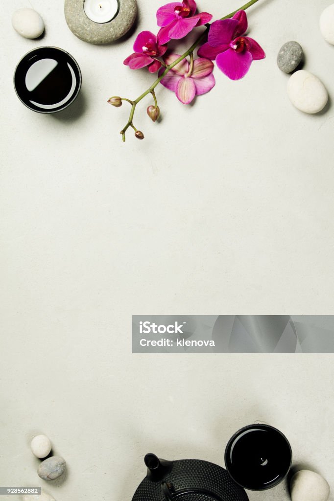 Asian tea set and spa stones on concrete background Asian tea set and spa stones on concrete background. Natural spa treatment and relaxation concept. Top view, flat lay, copyspace Backgrounds Stock Photo