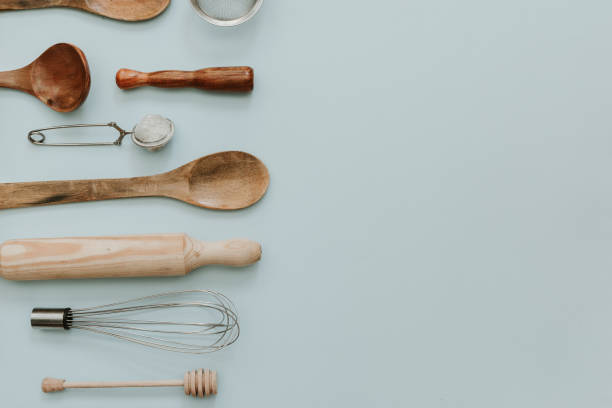 various kitchen utensils over pastel background. Flat lay minimal backing concept stock photo