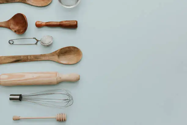 various kitchen utensils over pastel background. Flat lay minimal backing concept