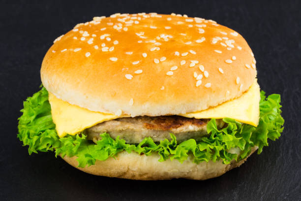 istock fresh tasty burger on black textured background 928566036