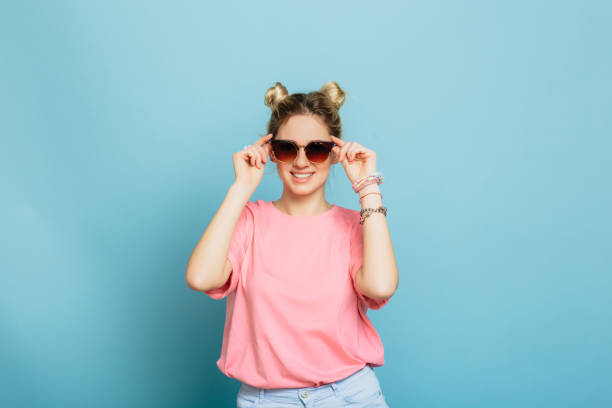 istock woman dressed in sunglasses on a blue background 928566642