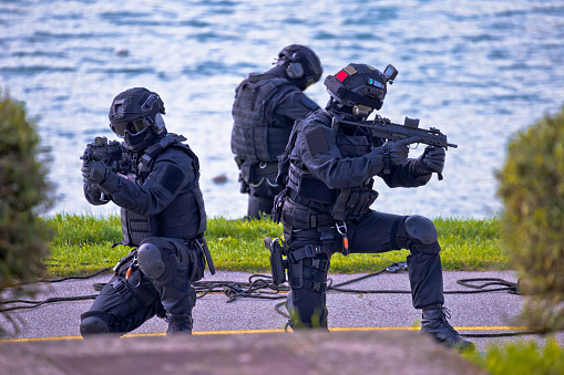 Special forces tactical team of three in action, unmarked and unrecognizable swat team