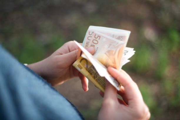 Close-up view of unrecognizable person counting (EU currency) money. Horizontal composition. Image taken with Nikon D800 and developed from Raw format.