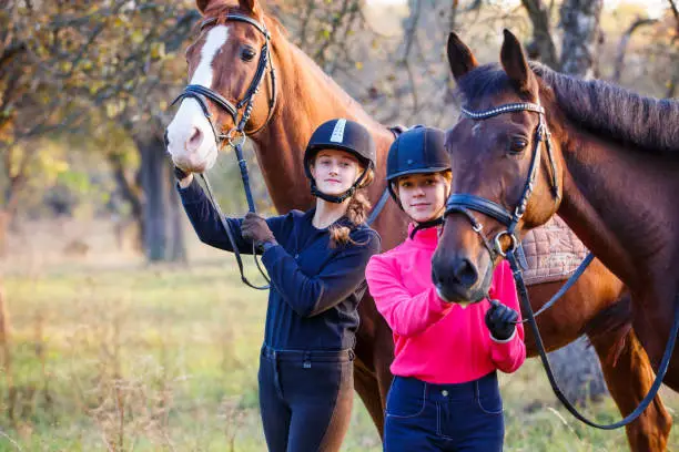 Photo of Two teenage girls with their horse in park