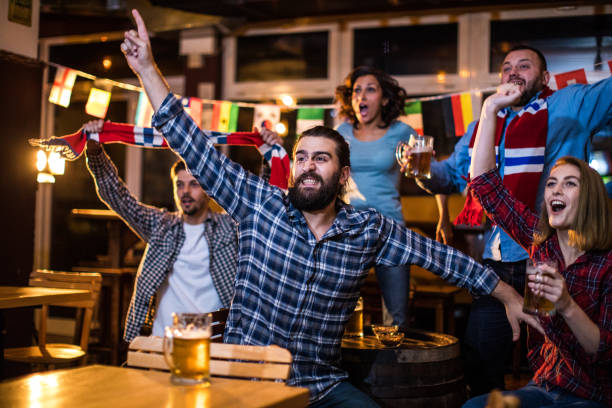 istock Friends watching sports on television 928579784