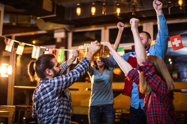 istock Young adults watching sports games with beer 928580016