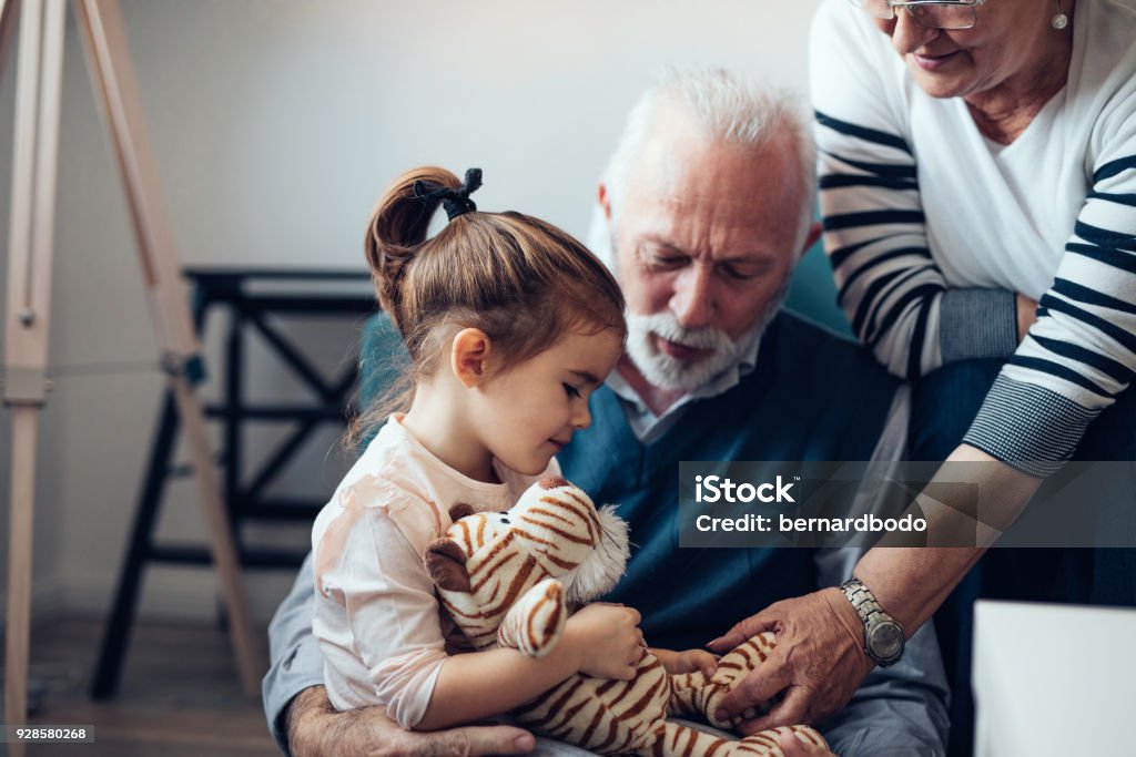 Comfort and care from her grandparents Grandparents playing with their granddaughter Grandparent Stock Photo