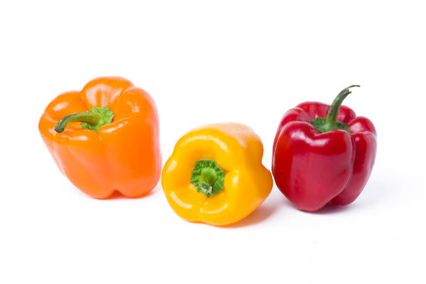 istock Red yellow and orange peppers on a white background. 928580632