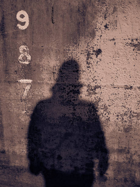 istock Tall Height Measurements Criminal Man Shadow Silhouette on Wall 928591798