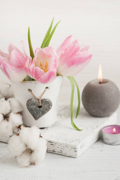 istock Pink tulip flowers, lit candles 928603362
