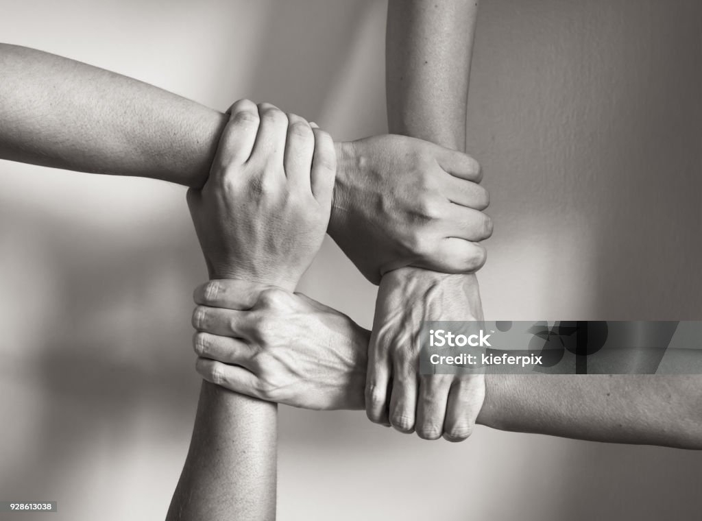 In unity there is strength Hands coming together. Black and white image. Black And White Stock Photo