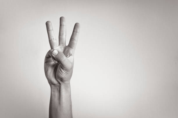 three fingers - american sign language imagens e fotografias de stock