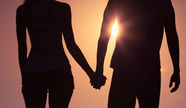 istock Couple holding hands at sunset 928613076