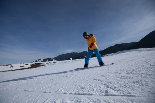 istock one snowboard snowboarding descent on slope in ski resort 928616806