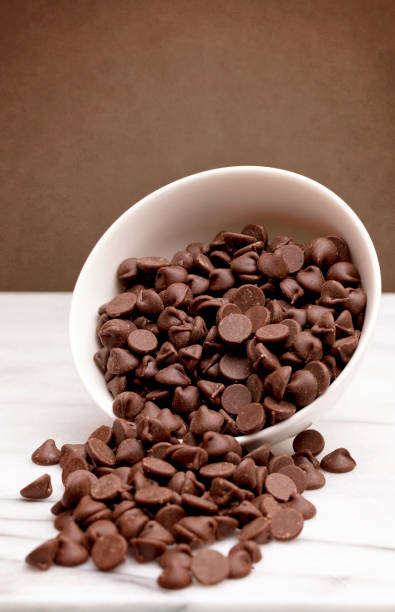 istock White Bowl of Chocolate Chips on a Marble Surface 928625840