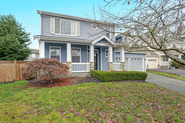 istock Charming blue two story home with a nice covered porch. 928635954