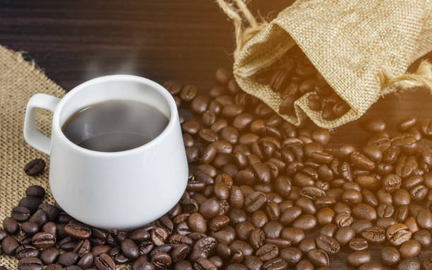 istock Close-Up Of Coffee Cup With Beans On Table 928651440