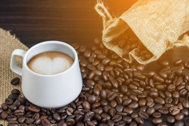 istock Close-Up Of Coffee Cup With Beans On Table 928651456