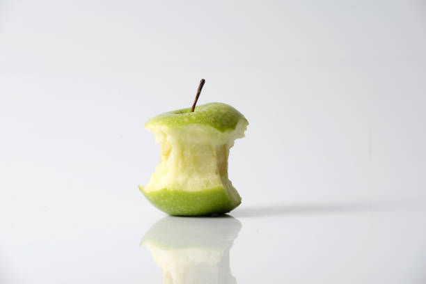 istock Close-Up On Eaten Granny Smith Apple Against White Background 928651780