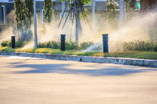 istock Automatic lawn sprinklers watering over green grass in the garden 928652744