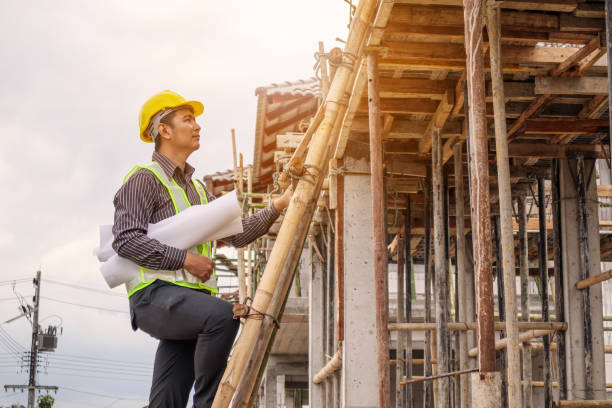 istock professional engineer worker at the house building construction site 928652760