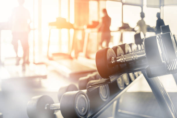 Rows of dumbbells in the gym with hign contrast and monochrome color tone Rows of dumbbells in the gym with hign contrast and monochrome color tone mass unit of measurement photos stock pictures, royalty-free photos & images