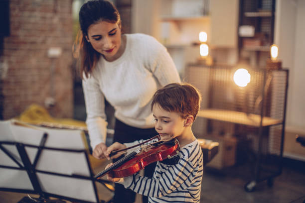 istock Cute boy teaching to play violin 928653420