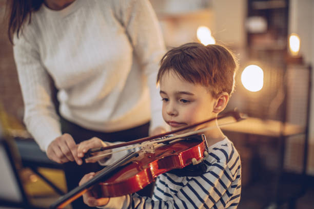 istock Little boy teaching to play violin 928656146