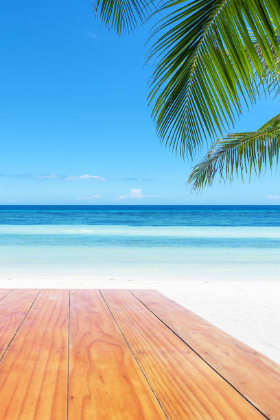 istock Empty wooden table beside tropical paradise beach 928656940