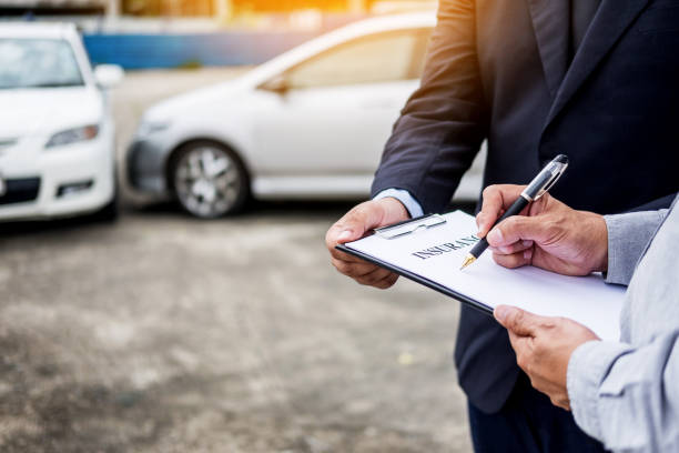istock Midsection Of Man Signing Car Insurance Form 928675064