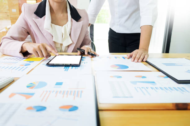 istock Midsection Of Business People Working On Digital Tablet At Office 928675684