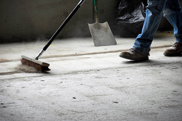 Worker Sweeping Up at Construction Site  sweeping photos stock pictures, royalty-free photos & images