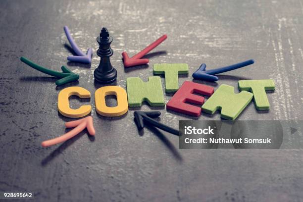 Content Is King In Advertising And Communication Concept Colorful Arrows Pointing To The Word Content At The Center With Chess King On Black Cement Wall Creativity Of Brand Website And Social Media Stock Photo - Download Image Now