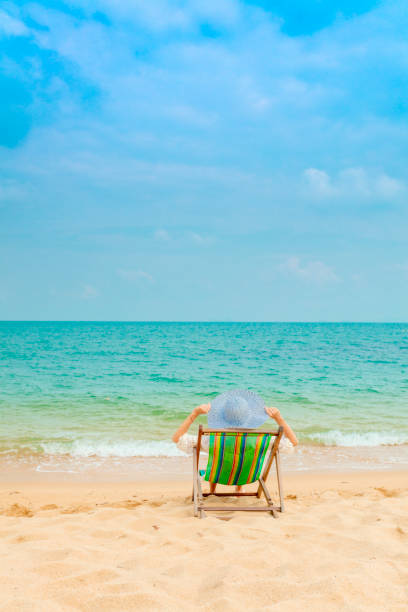 istock Woman in beach chair 928696352