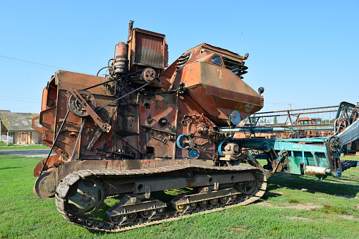 Russia, Poltavskaya village - September 6 2015: Old rusty disassembled combine harvester. Combine harvesters Agricultural machinery