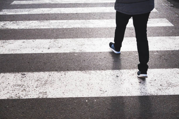 istock Low Section Of Woman Walking On Zebra Crossing 928699088