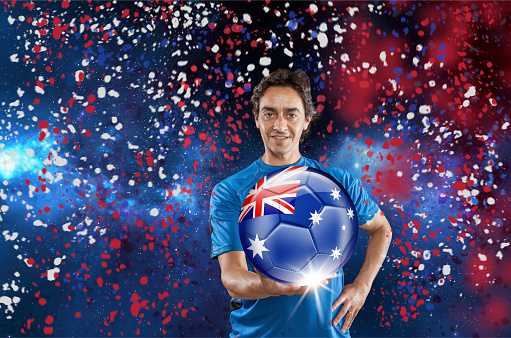 Soccer player Australia holding ball with australian flag under confetti