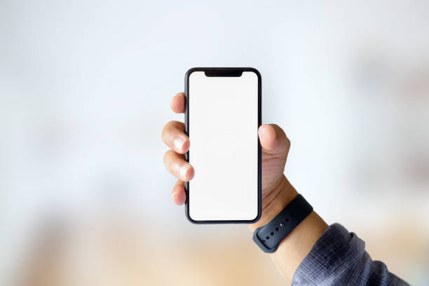 istock Cropped shot of man hand with empty smart phone on blurred background 928717630