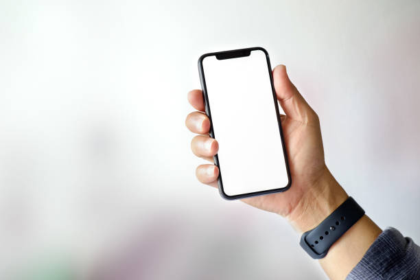 istock Cropped shot of man hand with empty smart phone on blurred background 928717632
