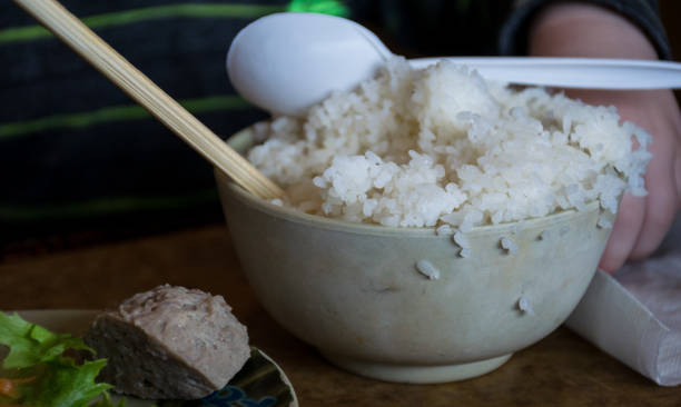 istock baby eating rice bowl 928718448