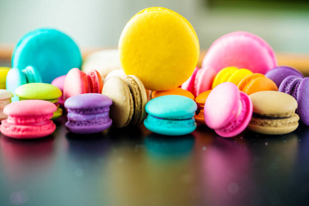 Close up yellow macarons dessert with vintage pastel tones. Colorful french macarons background,Different colorful macaroons background.Tasty sweet color macaron,Bakery concept.Selective focus.