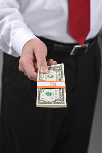 Man with bundle of cash stock photo