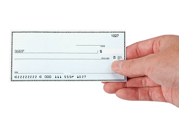 blank check being held stock photo