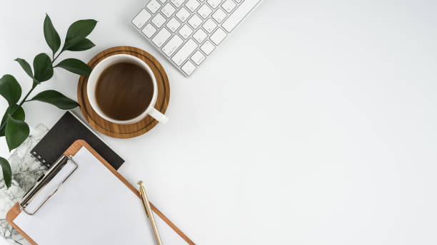 istock Styled stock photography white office desk table with blank notebook, computer, supplies and coffee cup. Top view with copy space. Flat lay. 928721762