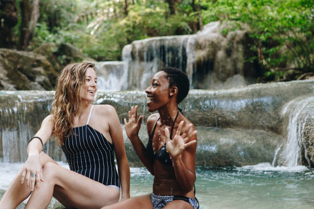istock Women couple enjoying the waterfall 928722056
