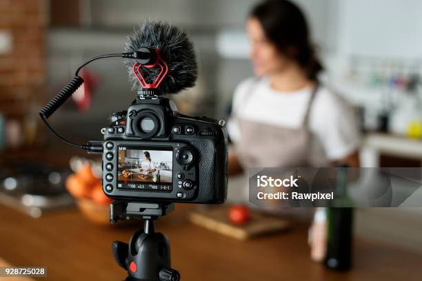 Female Vlogger Recording Cooking Related Broadcast At Home Stock Photo - Download Image Now