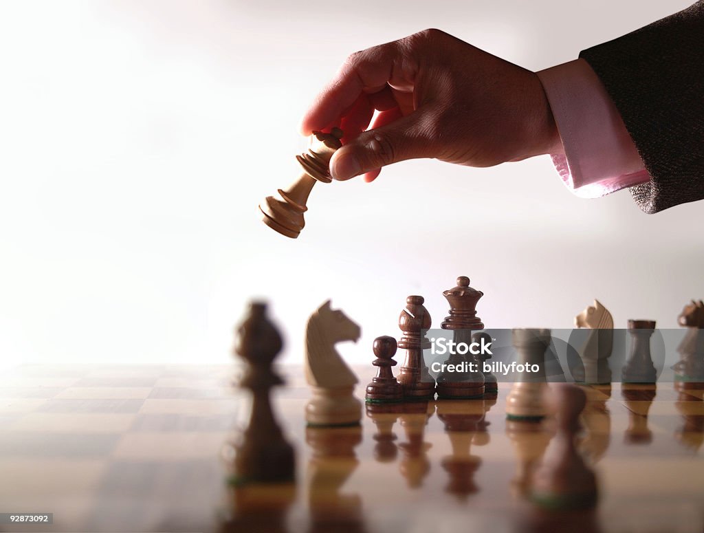 Wood chess board and hand holding queen  Boarding Stock Photo