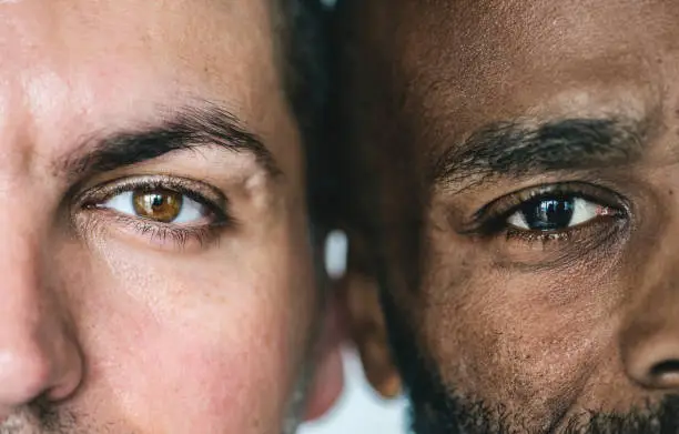 Photo of Two different ethnic men's eyes closeup